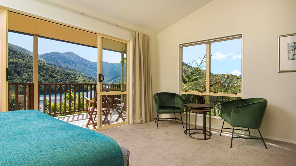 Fern Studios include a spacious bedroom and seating area with a private balcony for relaxing and enjoying scenic Endeavour Inlet views at Punga Cove in the Marlborough Sounds of New Zealand