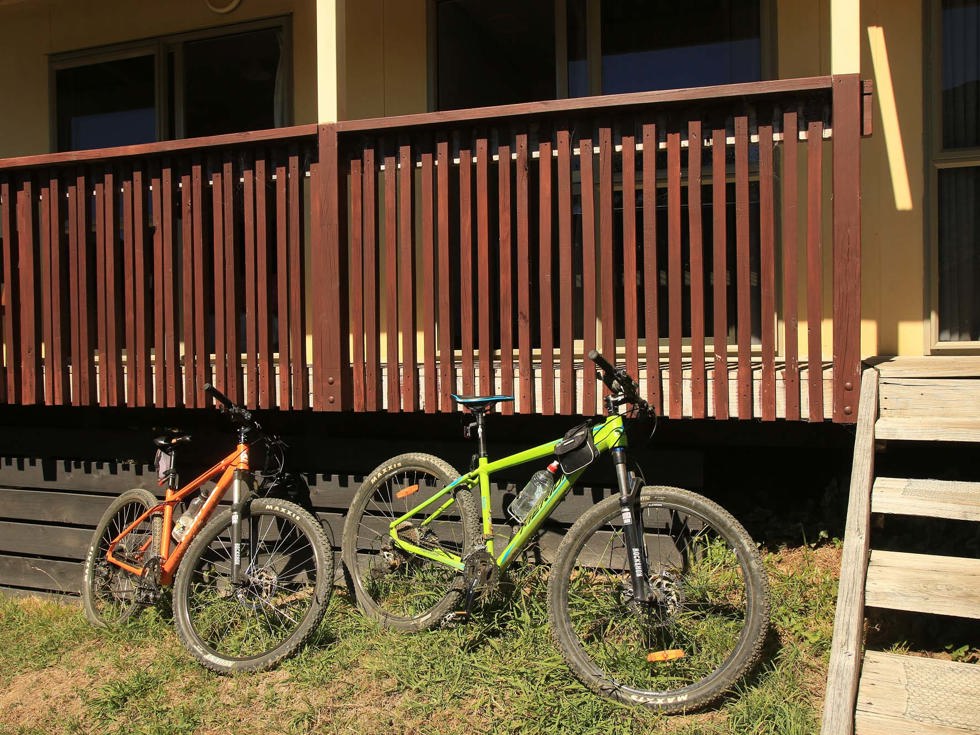 Queen Charlotte Track bikes rest beside the Basecamp accommodation balcony at Punga Cove in the Marlborough Sounds in New Zealand's top of the South Island