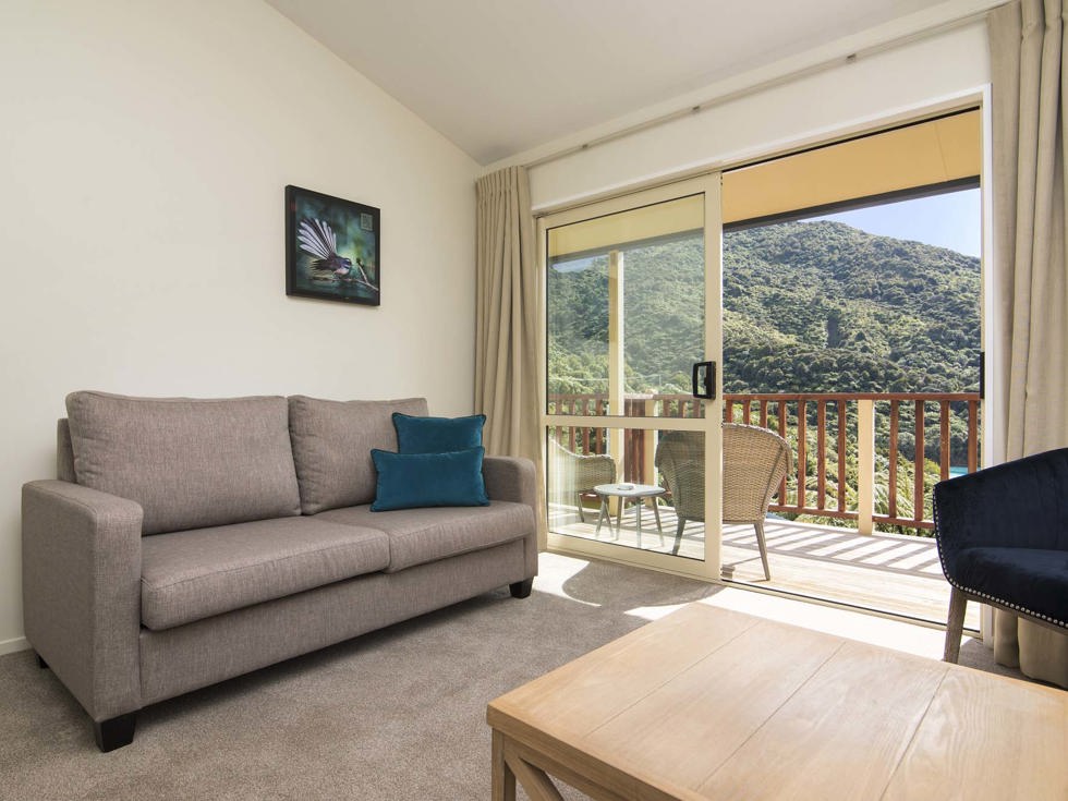 Frond Suite accommodation rooms have a spacious lounge area with sofas and seating and private balcony at Punga Cove in the Marlborough Sounds in New Zealand's top of the South Island