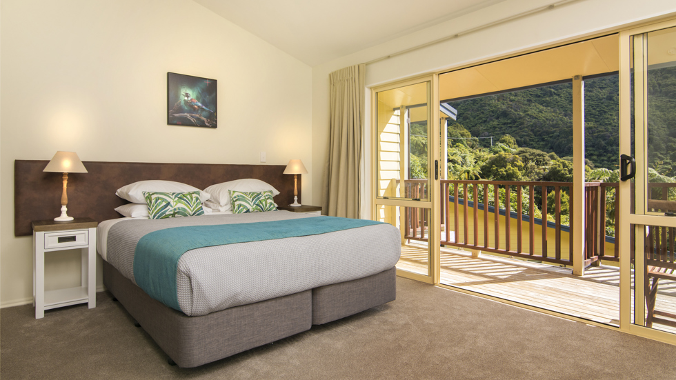 Fern Studios include a spacious bedroom with a private balcony for relaxing and enjoying scenic Endeavour Inlet views at Punga Cove in the Marlborough Sounds of New Zealand