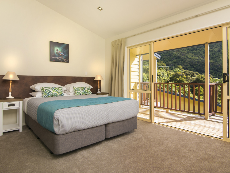 Fern Studios include a spacious bedroom with a private balcony for relaxing and enjoying scenic Endeavour Inlet views at Punga Cove in the Marlborough Sounds of New Zealand