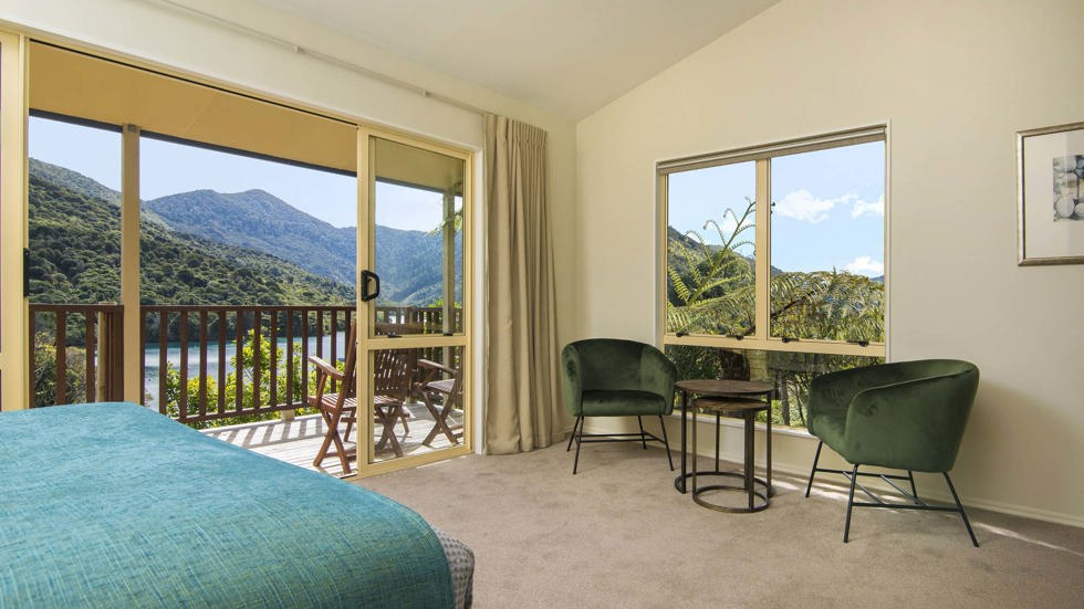 Fern Studios include a spacious bedroom and seating area with a private balcony for relaxing and enjoying scenic Endeavour Inlet views at Punga Cove in the Marlborough Sounds of New Zealand