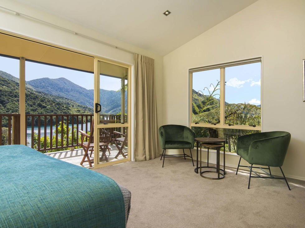 Fern Studios include a spacious bedroom and seating area with a private balcony for relaxing and enjoying scenic Endeavour Inlet views at Punga Cove in the Marlborough Sounds of New Zealand