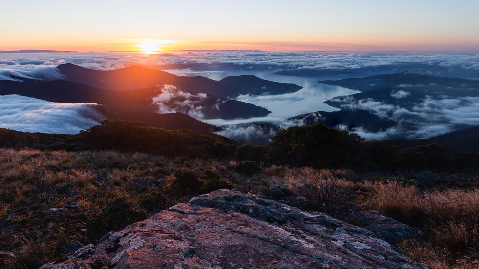 A beautiful sunrise from the top of Mount Stokes in the Marlborough Sounds in New Zealand's top of the South Island