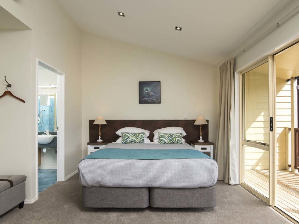 Fern Studios include a spacious bedroom area with a King bed and private balcony for relaxing and enjoying scenic Endeavour Inlet views at Punga Cove in the Marlborough Sounds of New Zealand