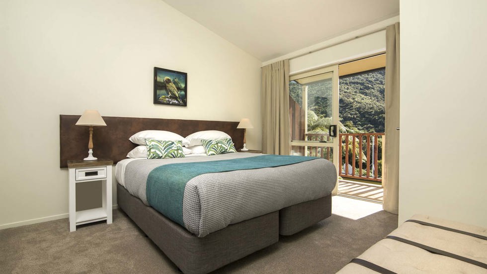 Frond Suites include a spacious bedroom area with a King bed and private balcony for relaxing and enjoying scenic Endeavour Inlet views at Punga Cove in the Marlborough Sounds of New Zealand